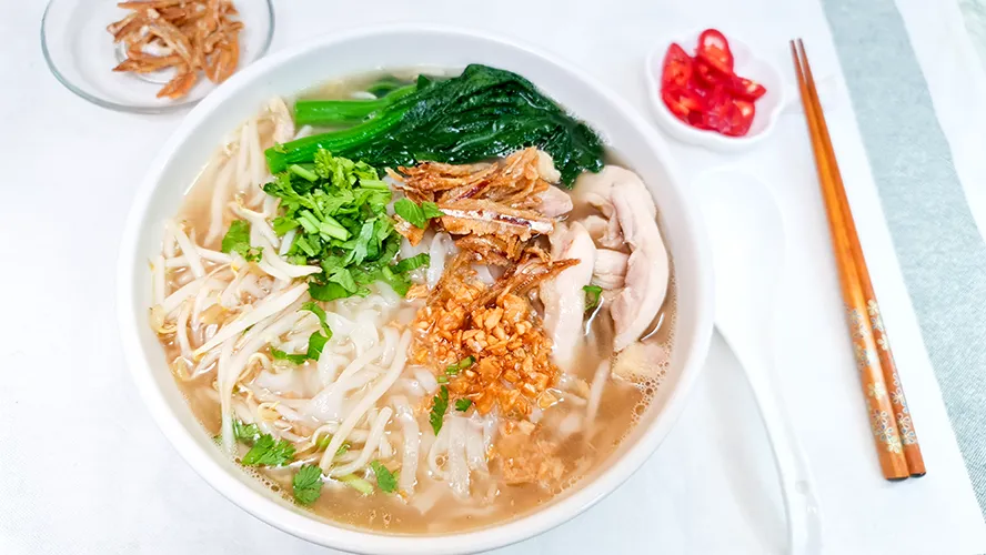 chicken kway teow soup distance Chicken Kway Teow Soup served with cut red chilli and crispy fried anchovies.