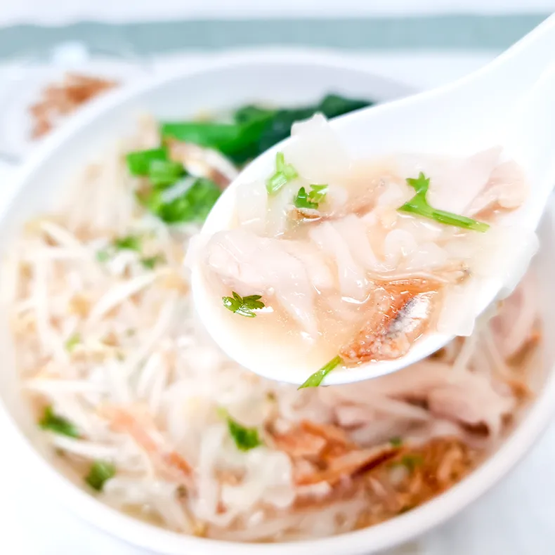 lets eat A spoonful of kway teow, chicken slices and an anchovy.