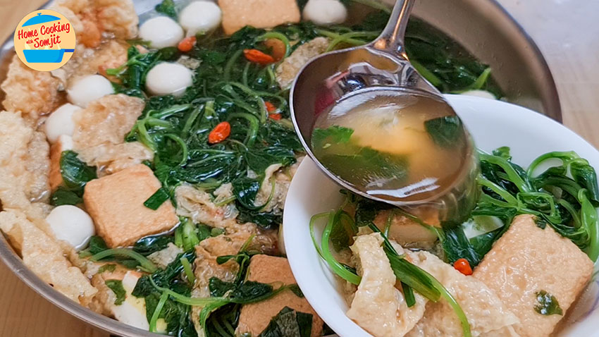 dishing soup Spatula dishing Fishball Spinach Soup into a bowl.