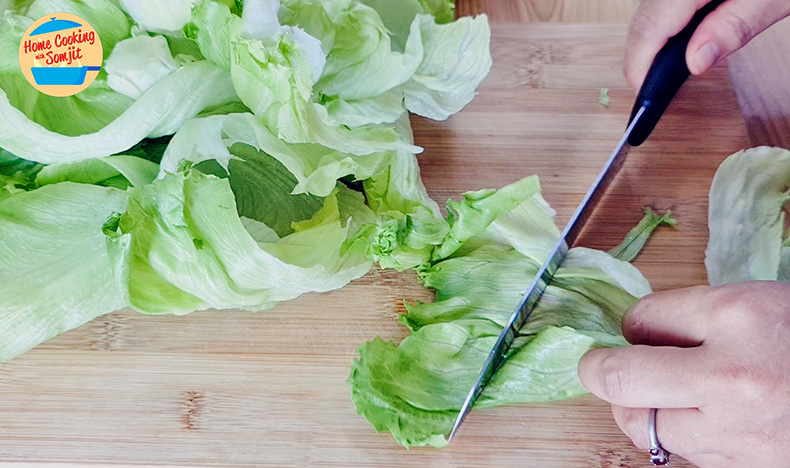 cutting lettuce Knife chopping lettuce into little squares.