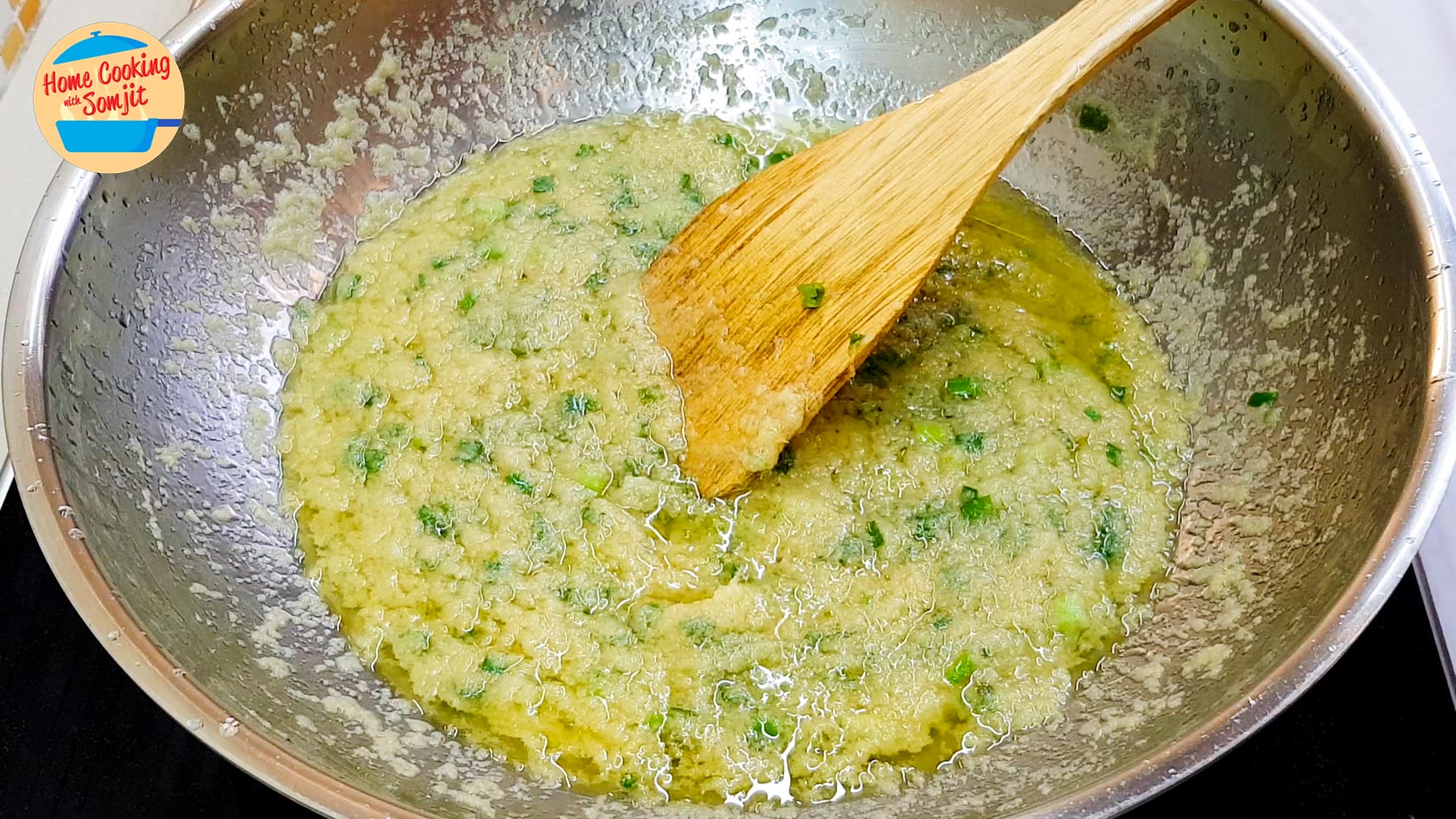 cooked ginger scallion sauce Spatula stirring ginger scallion sauce in pan.