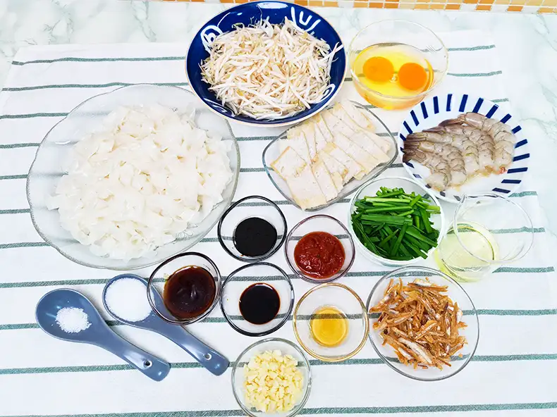 ingredients All the ingredients needed: kway teow for frying, beansprouts, eggs, fish cakes, prawns, chives, cooking oil, anchovies, chilli paste, light soy sauce, thick soy sauce, sesame oil, minced garlic, oyster sauce, salt and sugar.
