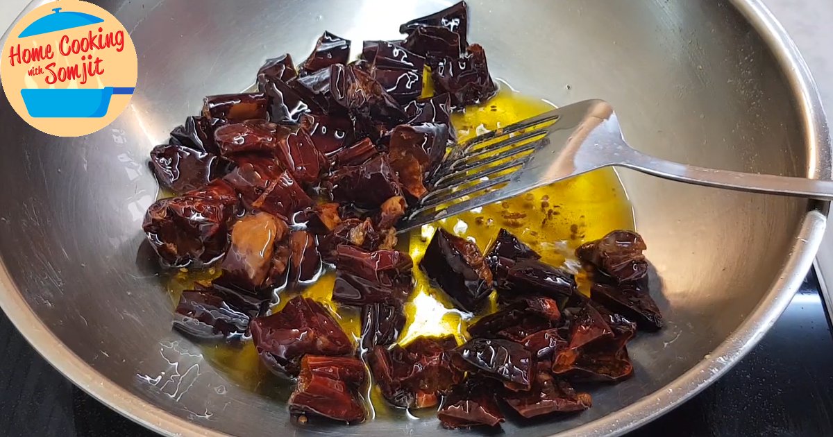 chilli done frying Large dried chopped Guajillo Peppers fried in oil.