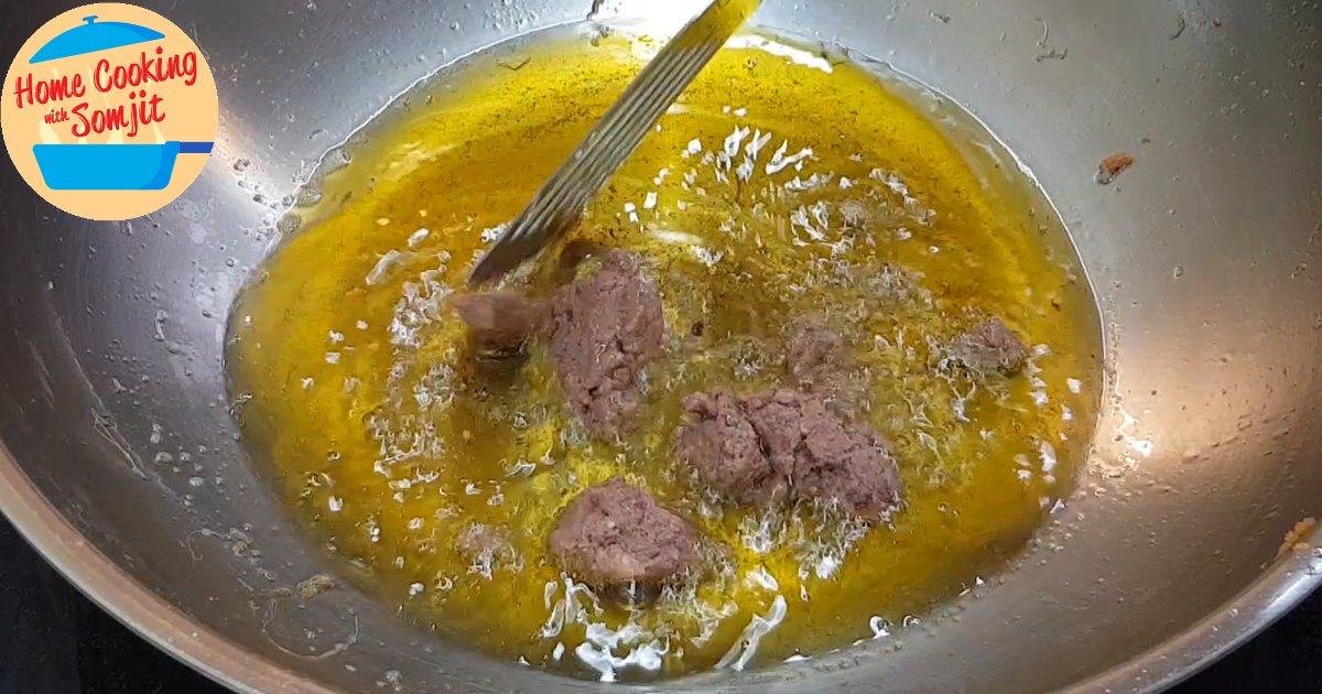 frying shrimp paste A lump of shrimp paste in hot oil.