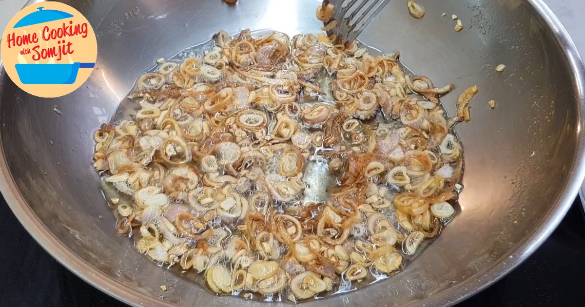 shallots done frying Light browned shallots in hot oil over a pan.